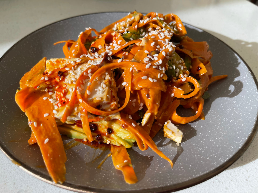 Raw carrot noodles with spicy peanut sauce